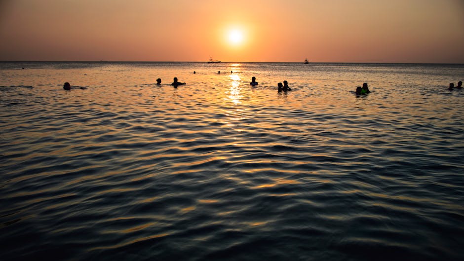 People swimming during a beautiful sunset in Santa Marta, Colombia.